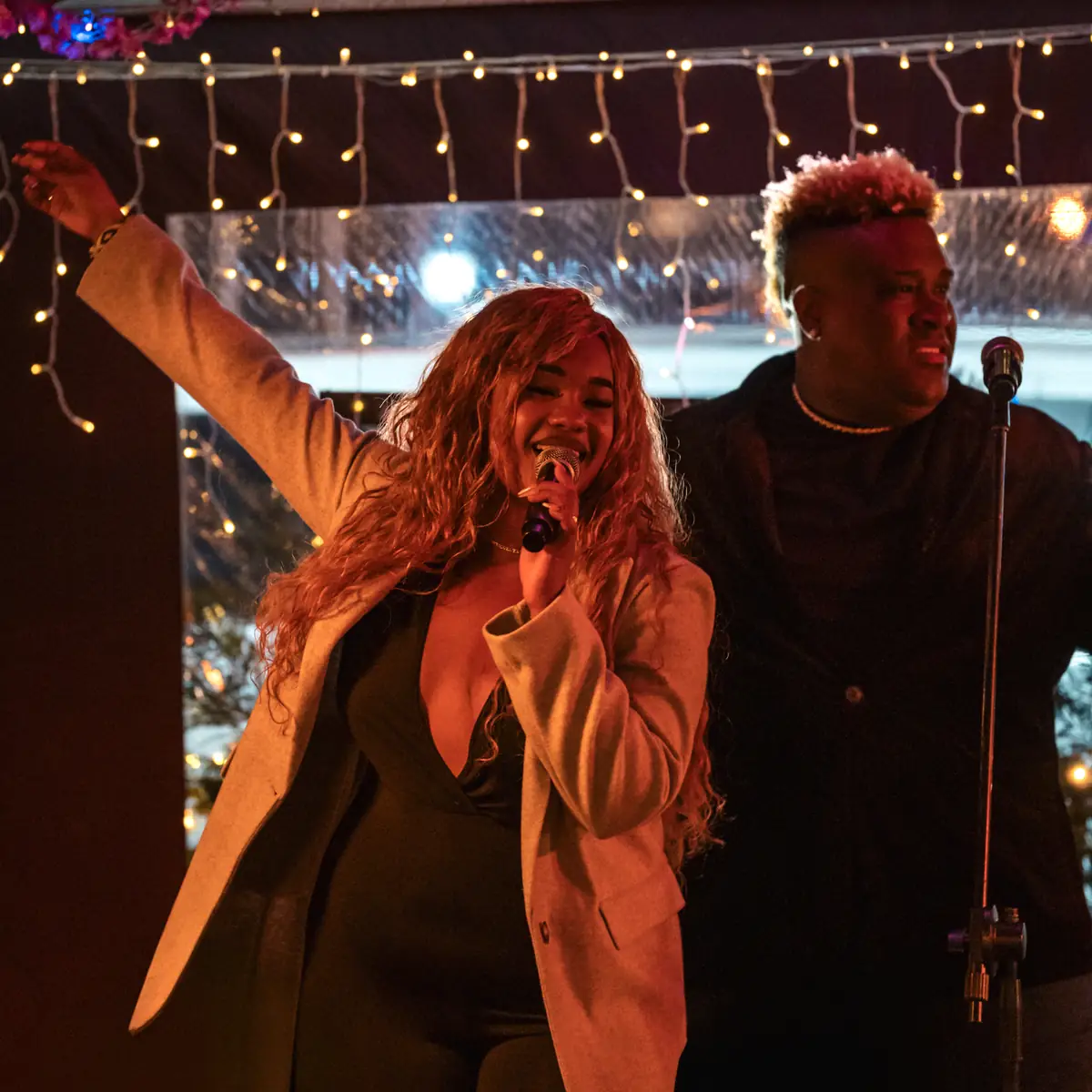 A singer with an arm raised mid-song during a weekend show at Pachamama