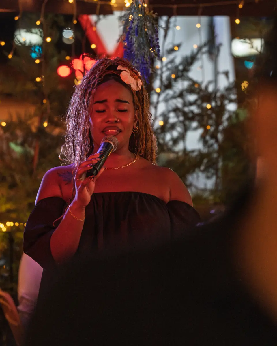 A vocalist holding a note during a Latin set at Pachamama