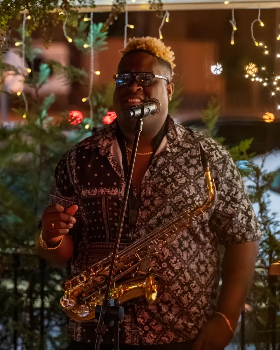 A saxophone solo under string lights on the Pachamama terrace